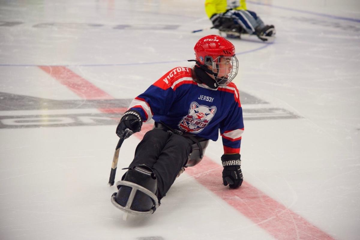 A female Para ice hockey player in a rink