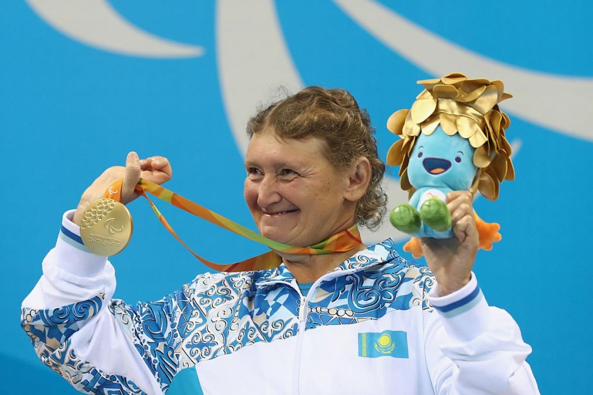 Zulfiya Gabidullina of Kazakhstan celebrates on the podium after winning gold in the Women's 100m Freestyle at the Rio 2016 Paralympic Games.