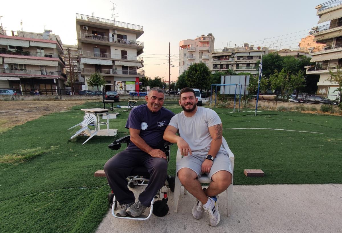 Two men in chairs in the middle of a square
