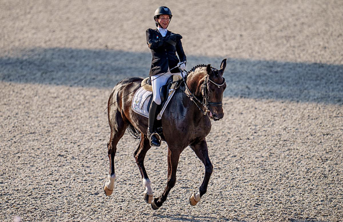 Philippa Johnson-Dwyer smiling riding her horse Just In Time