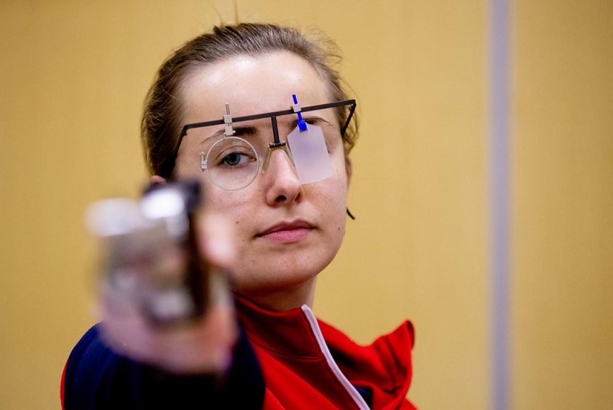 A woman with a pistol in a shooting range