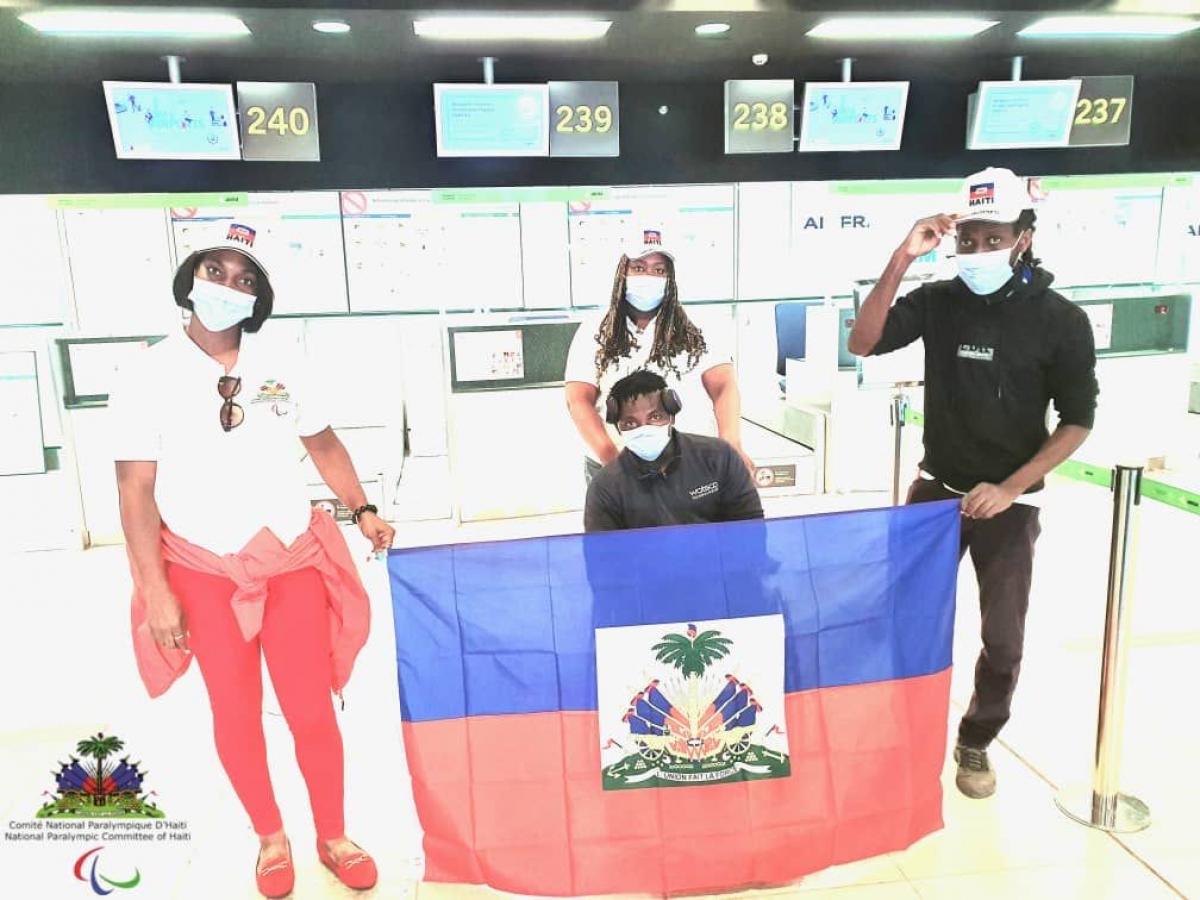 Team standing holding the Haiti flag