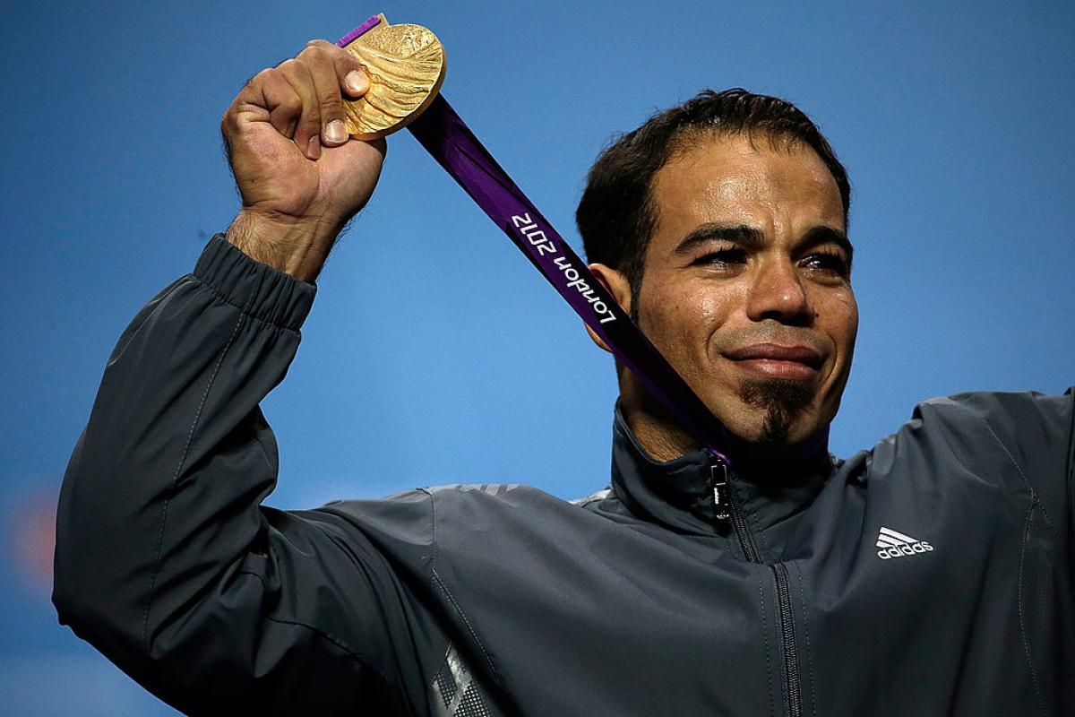 Sherif Osman holds up his London 2012 gold medal