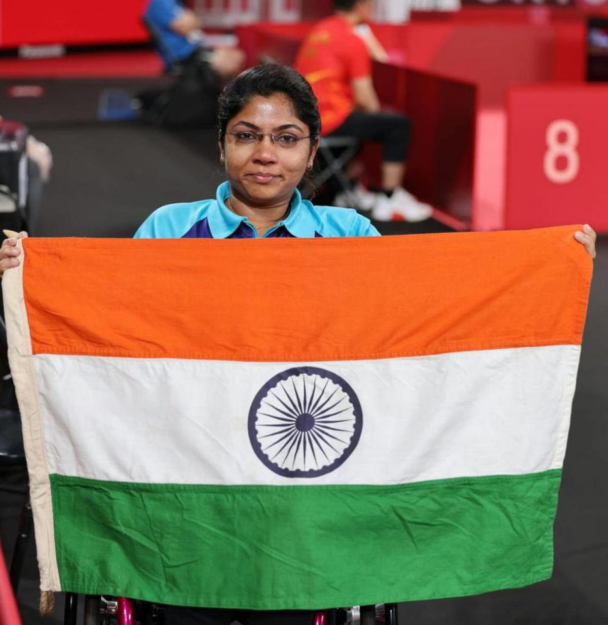 Bhavinaben Patel poses with the Indian flag after her historical performance