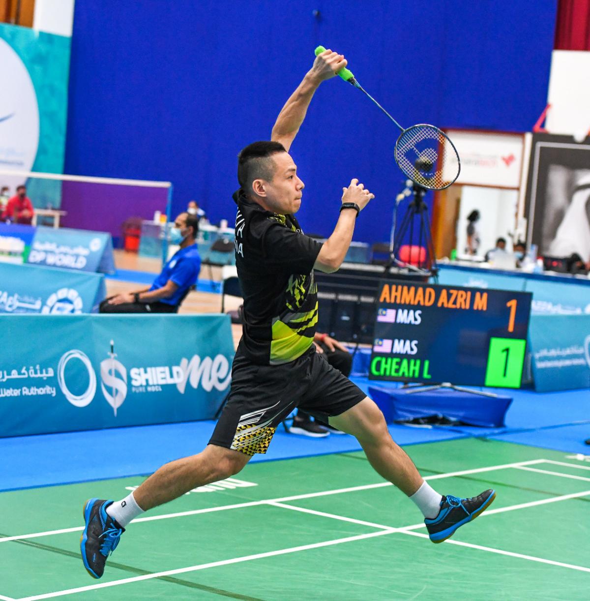 Malaysia's Cheah Liek Hou jumps in the air playing badminton