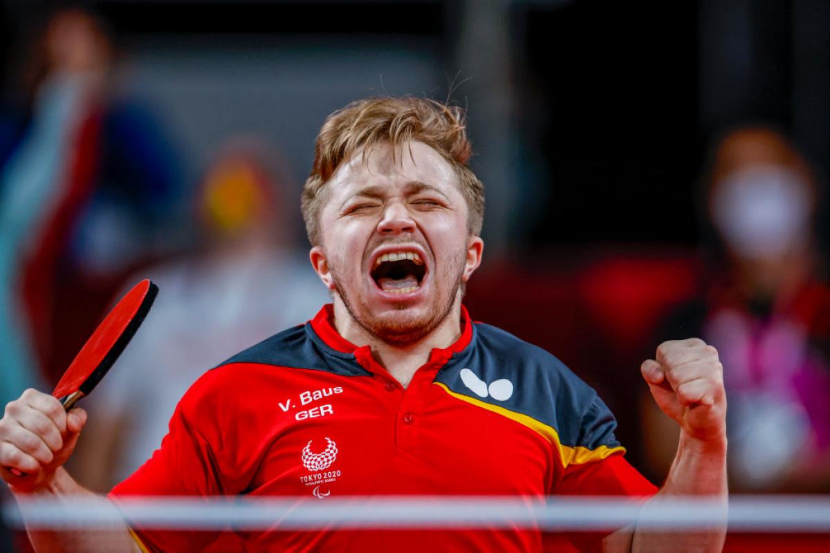 German male table tennis player celebrates