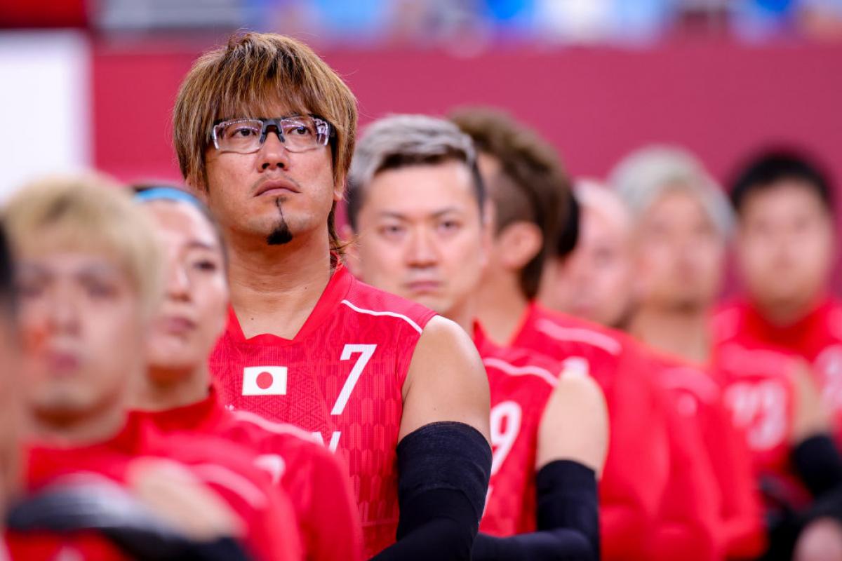 Japanese male wheelchair rugby player and his team line up for the anthem