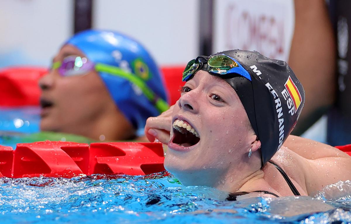 A woman with a big smile in the pool