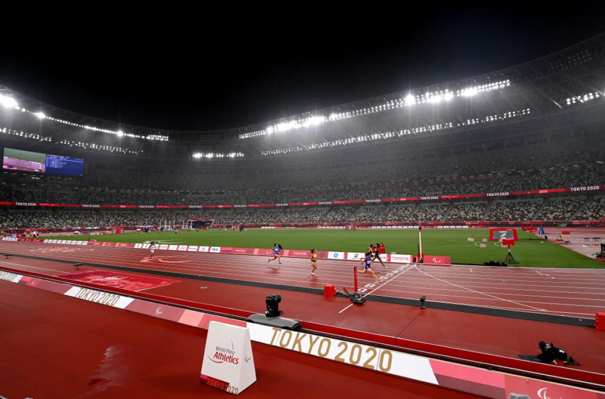 An athletics stadium during a rainy evening 