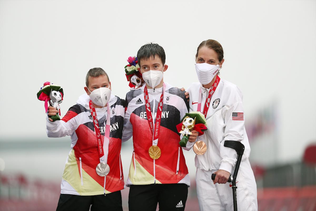 Three women on podium with medals