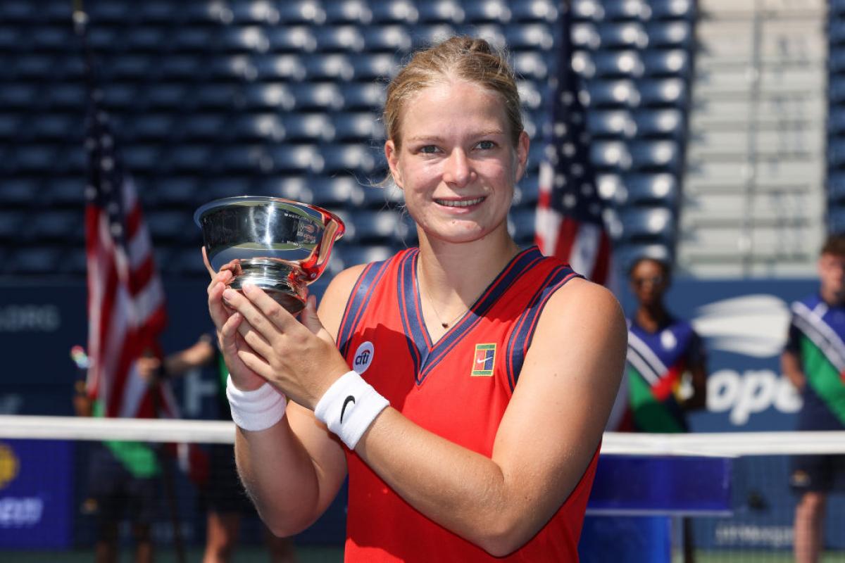 Woman holds up US Open trophy
