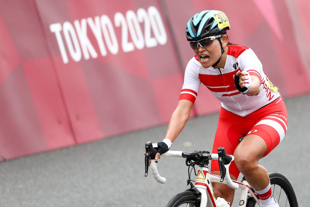 Japanese female cyclist celebrates on her bike