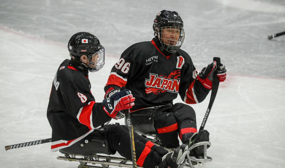 Two players on sledges looking in front of them