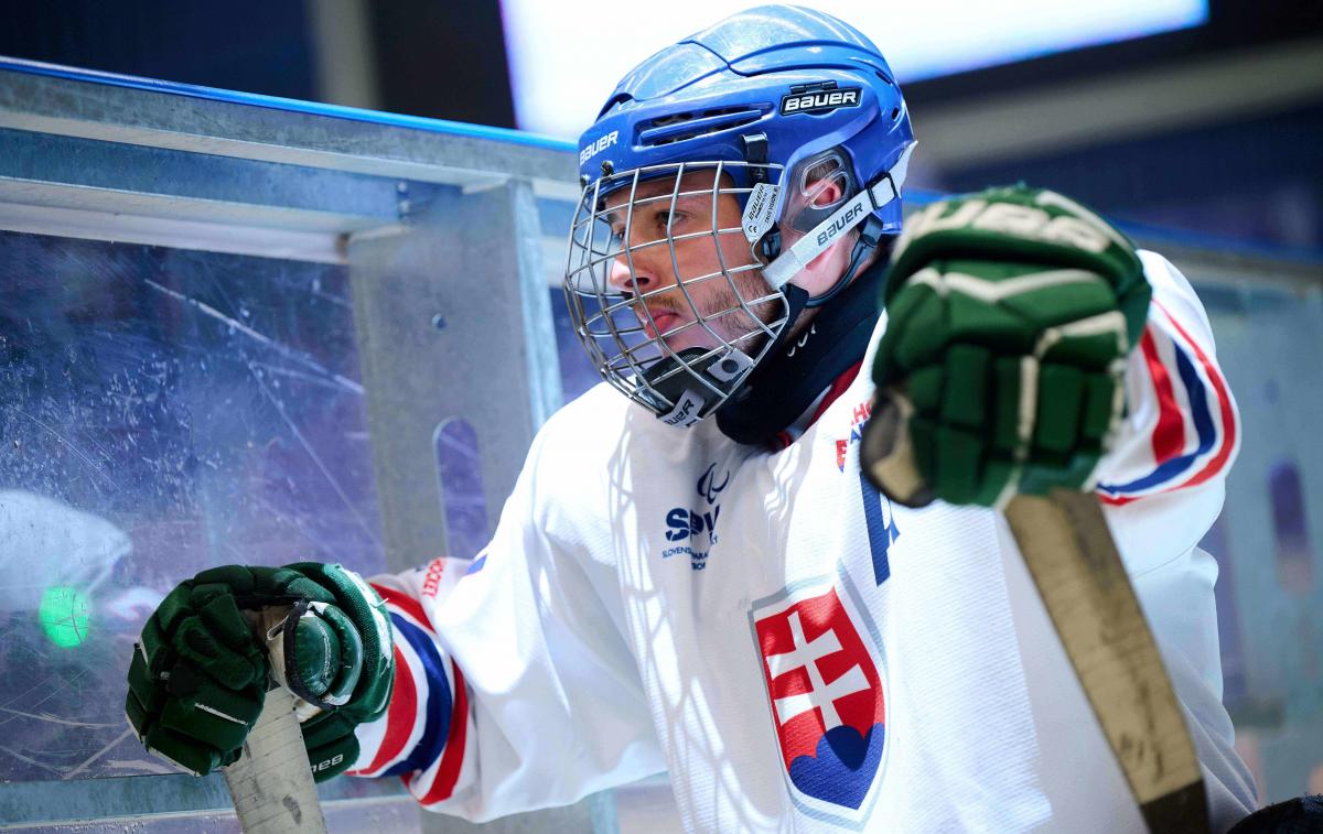 A Para ice hockey player gazing on the bench