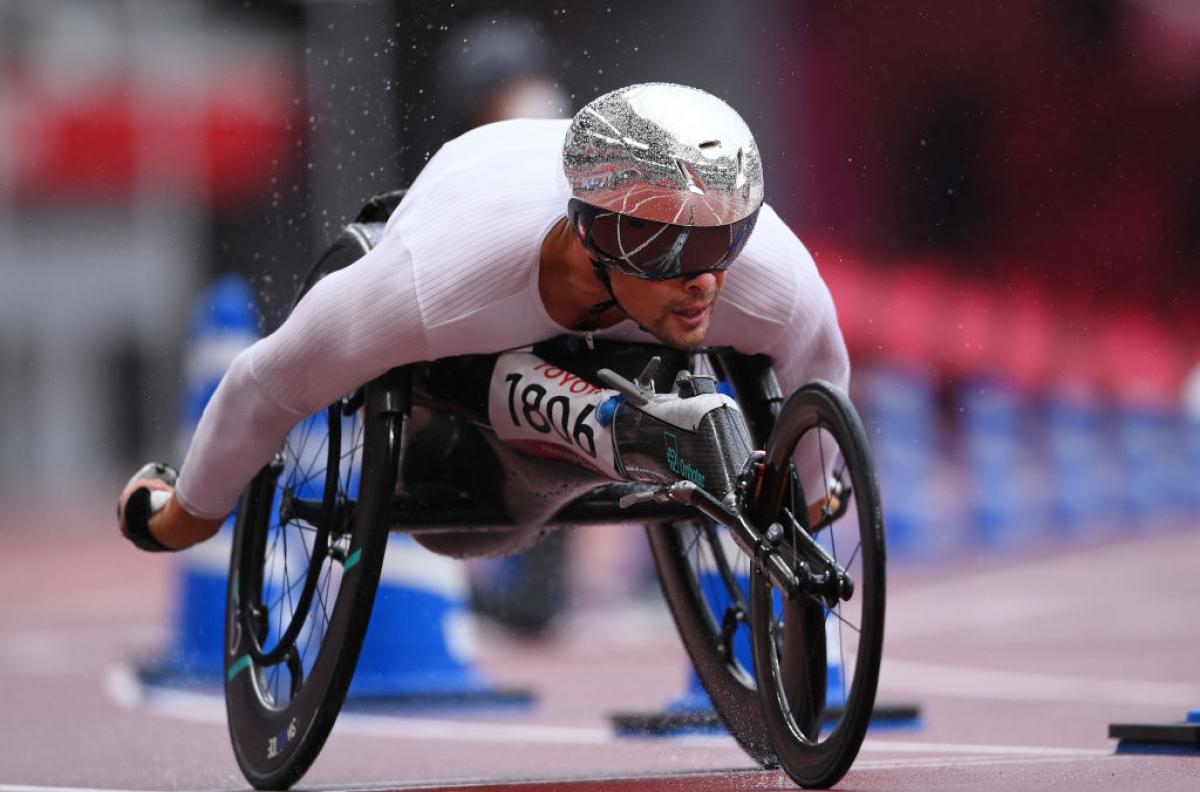 A male wheelchair racer competing in an athletics track
