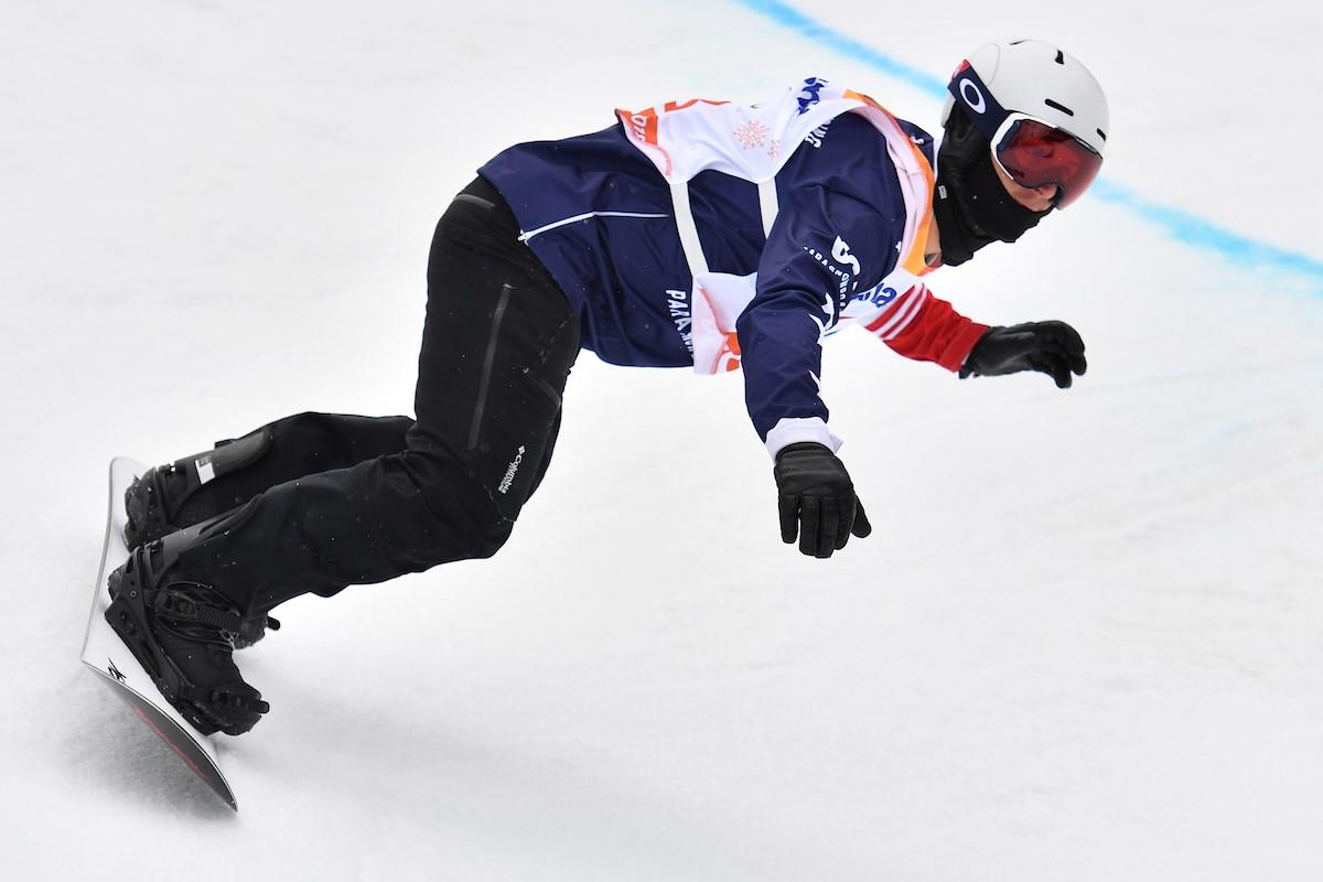 A male Para snowboarder competing 