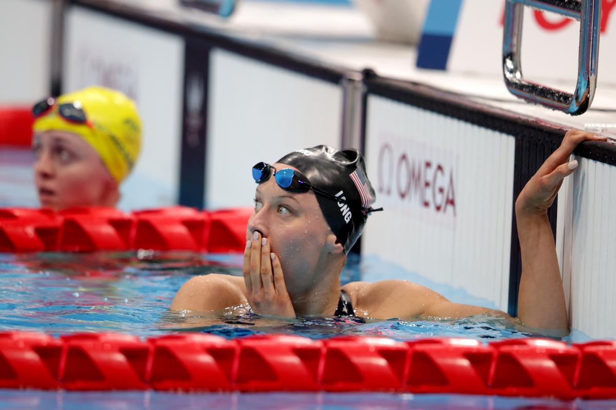 A female swimmer with a surprised expression in the pool