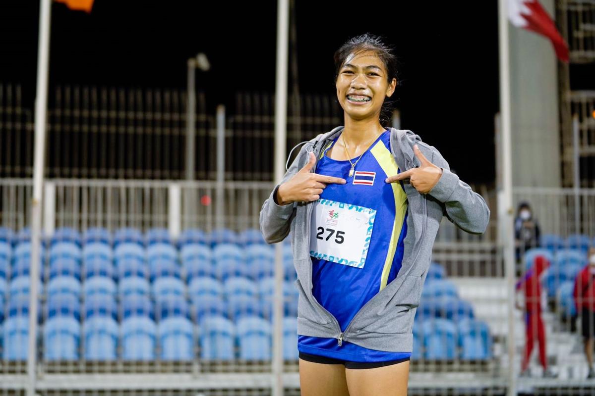 An athlete showing the flag of Thailand on her uniform