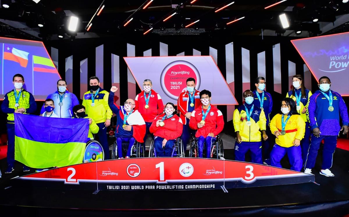 A group of athletes from Ukraine, Chile and Colombia on a podium