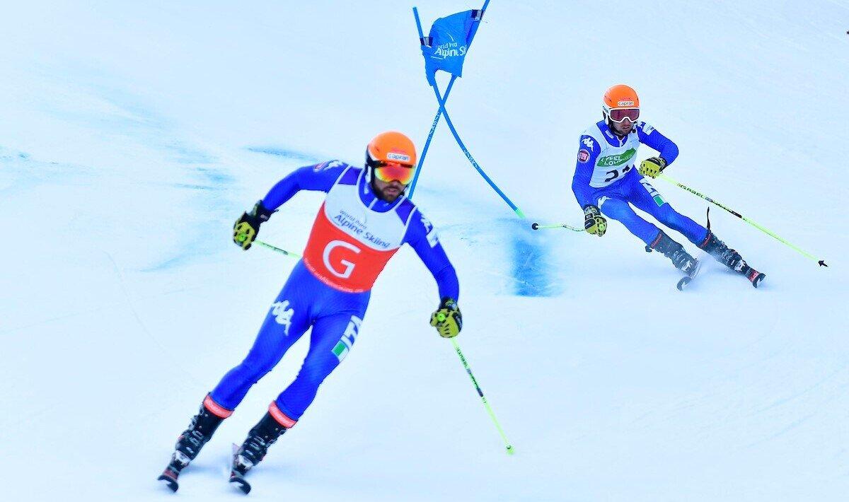 A guide leading the vision-impaired skier during the race