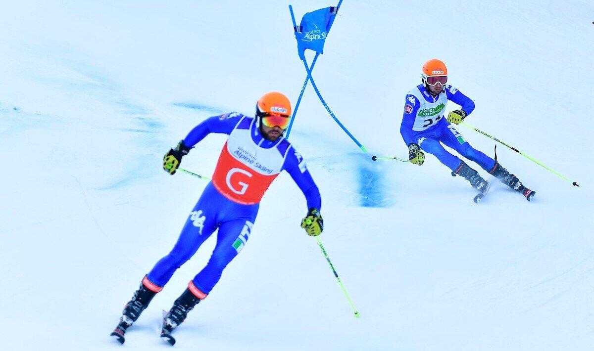 A guide leading the vision-impaired skier during the race