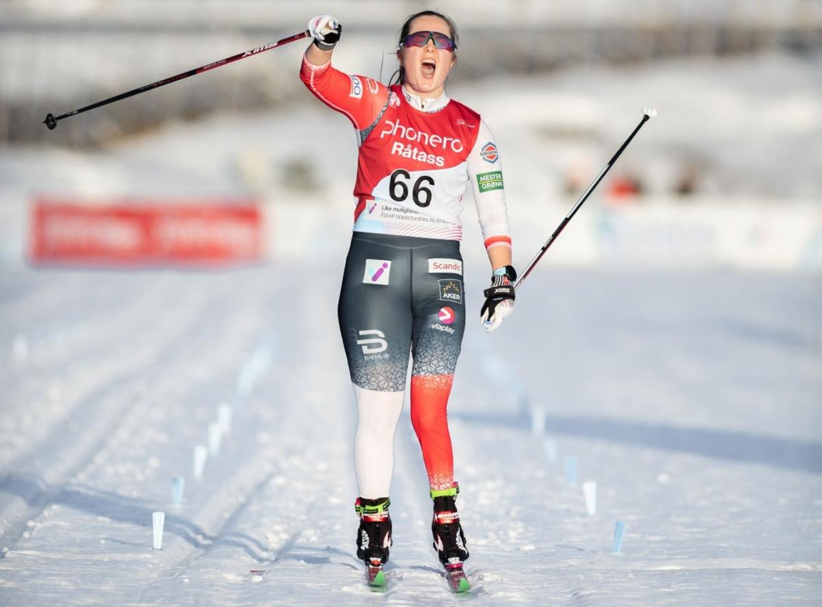 A female skier celebrating on a cross-country track