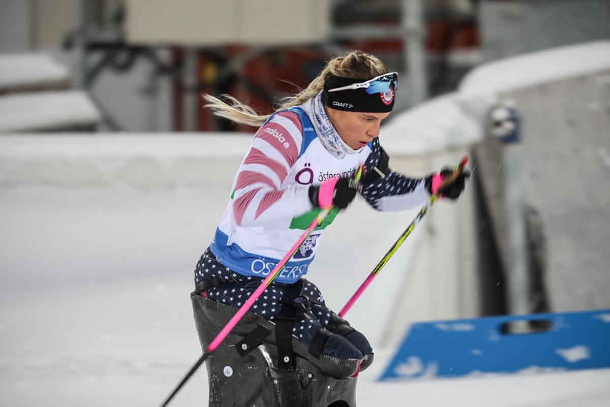 A female sit-skier in a Para cross-country skiing competition