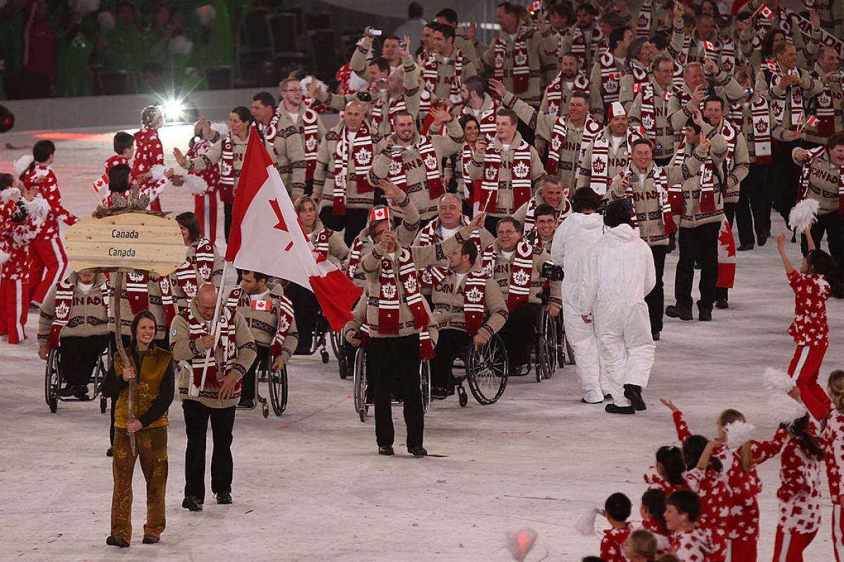 Flag bearer Jean Labonte of Canada leads his team through the stadium during the Opening Ceremony of the 2010 Vancouver Paralympic Winter Games. 