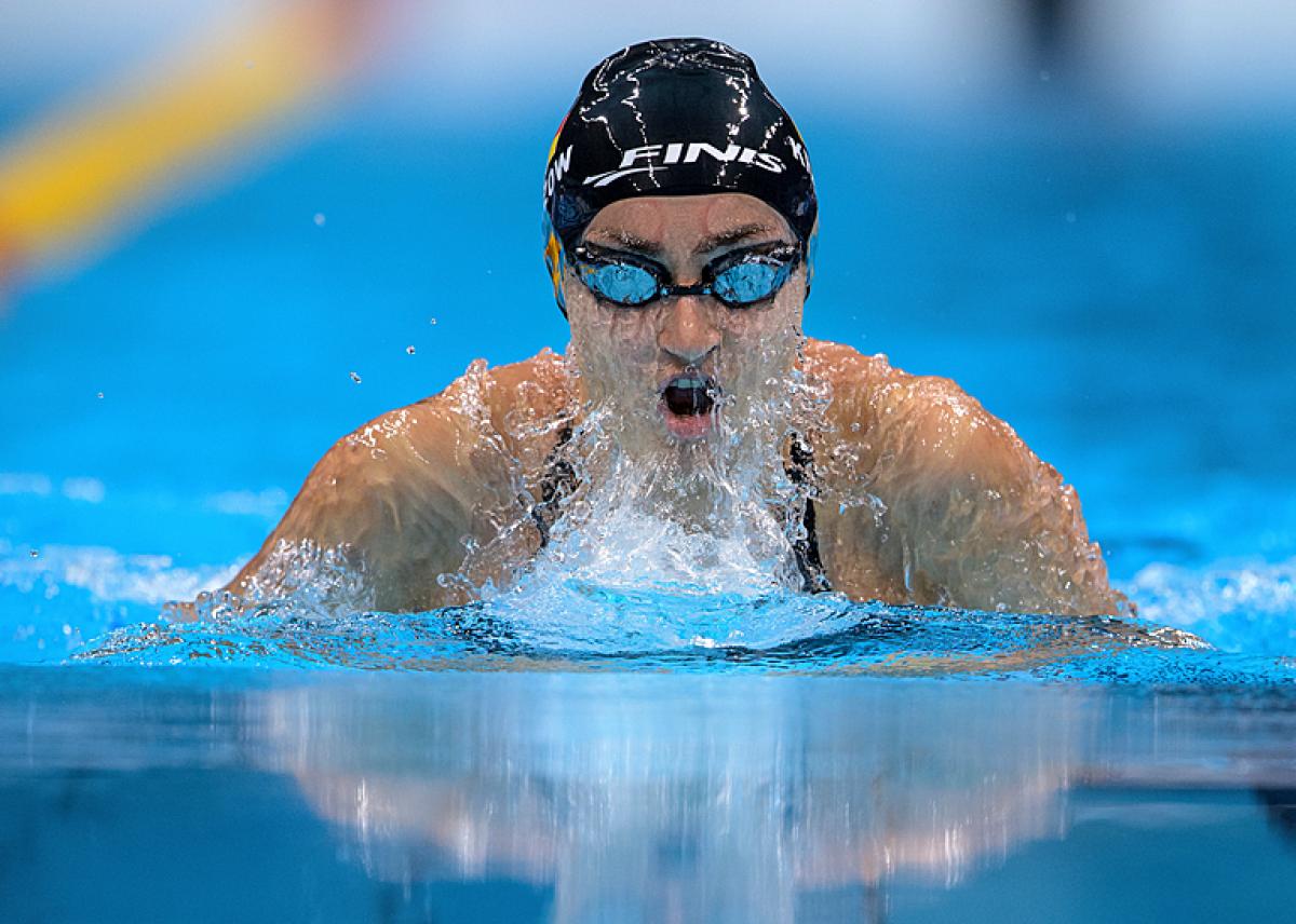 A female Para swimming swimming breaststroke in a pool