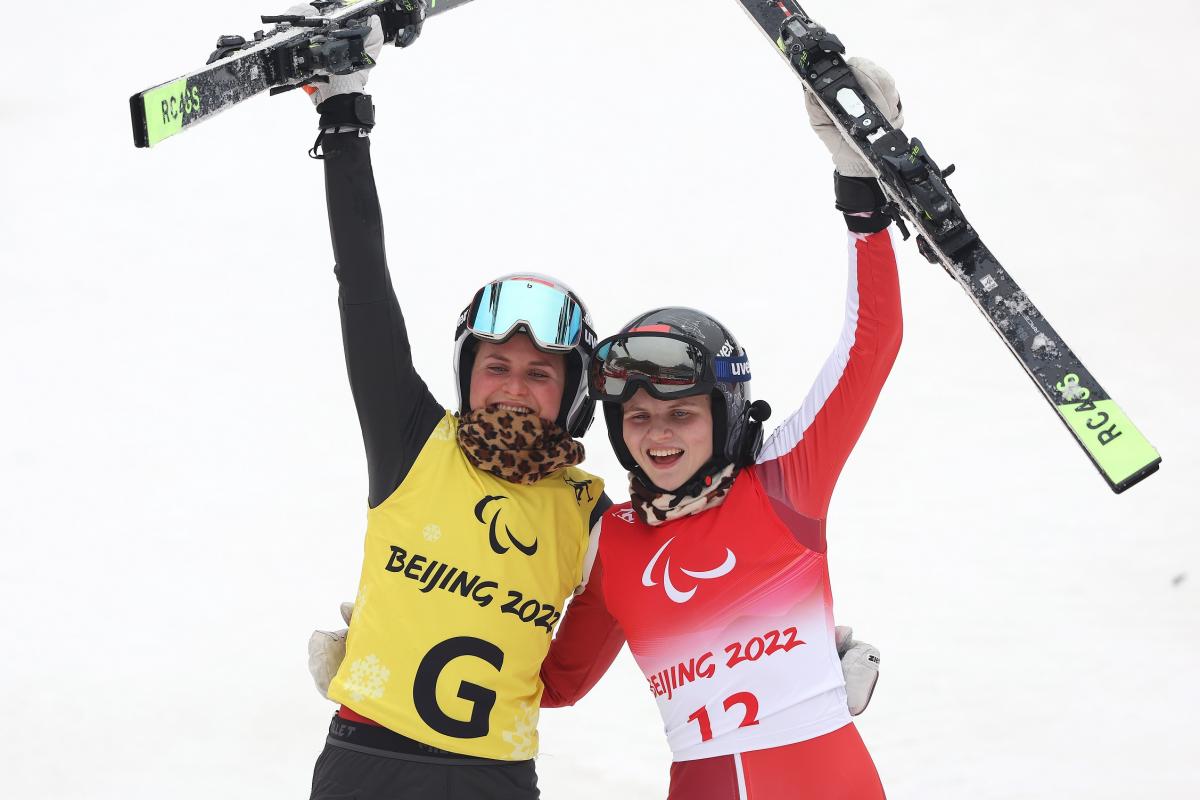 Veronika Aigner and guide and sister Elisabeth Aigner react after winning the giant slalom gold medal