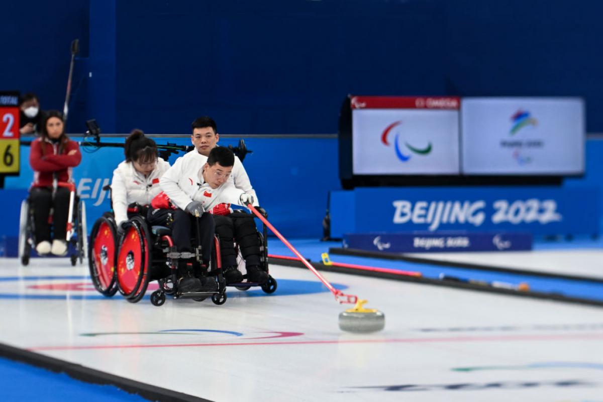 A Chinese wheelchair curler releases a stone