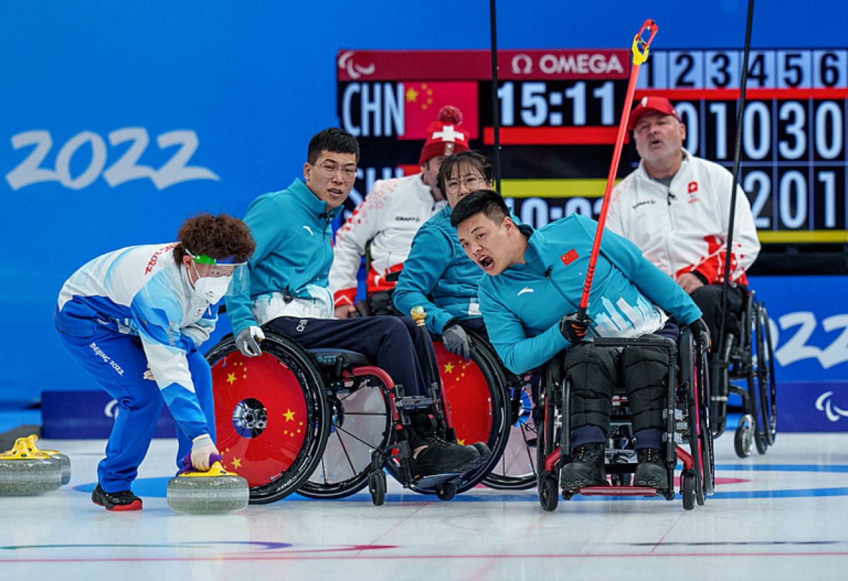 A Chinese wheelchair curlers reacts after releasing a stone