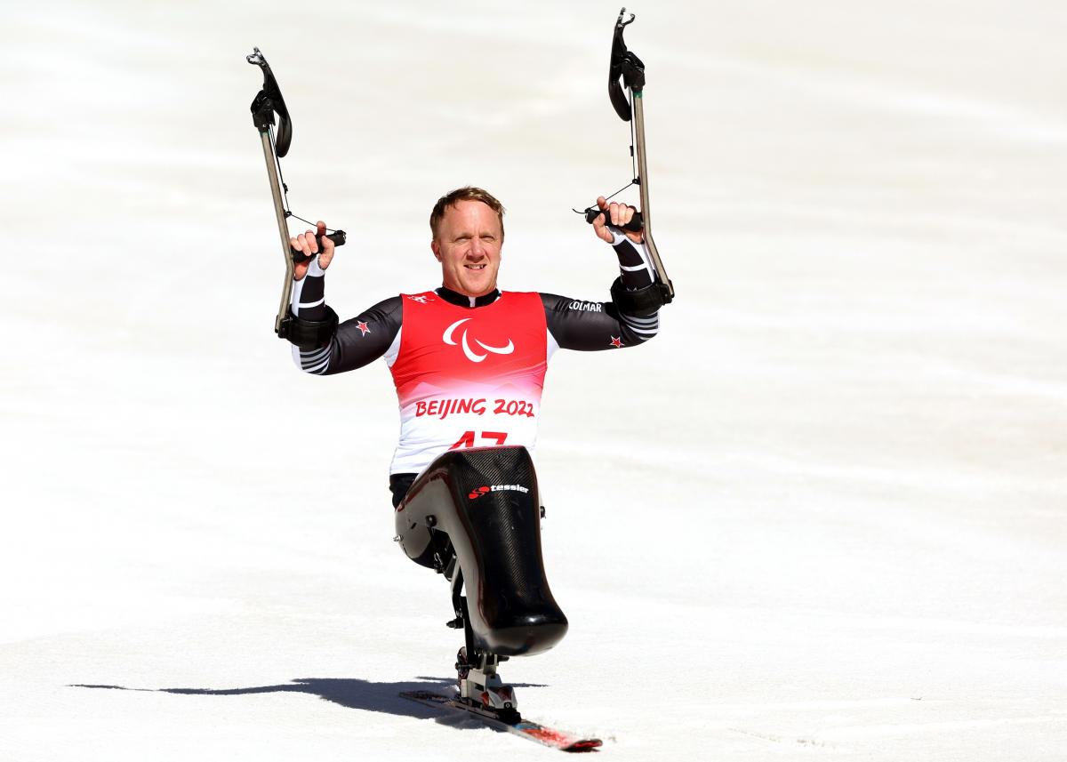 Corey Peters celebrates after winning his first Winter Paralympic gold in Beijing