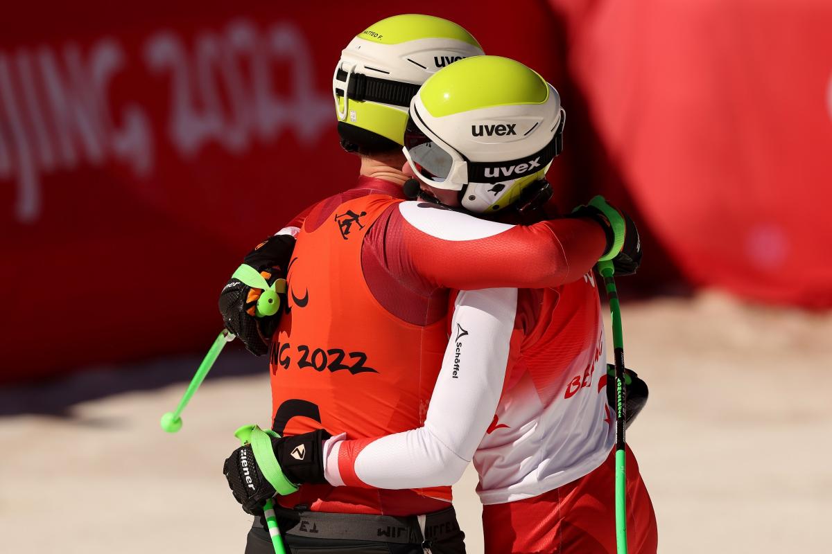 Johannes Aigner of Team Austria and his guide Matteo Fleischmann react after crossing the finish line