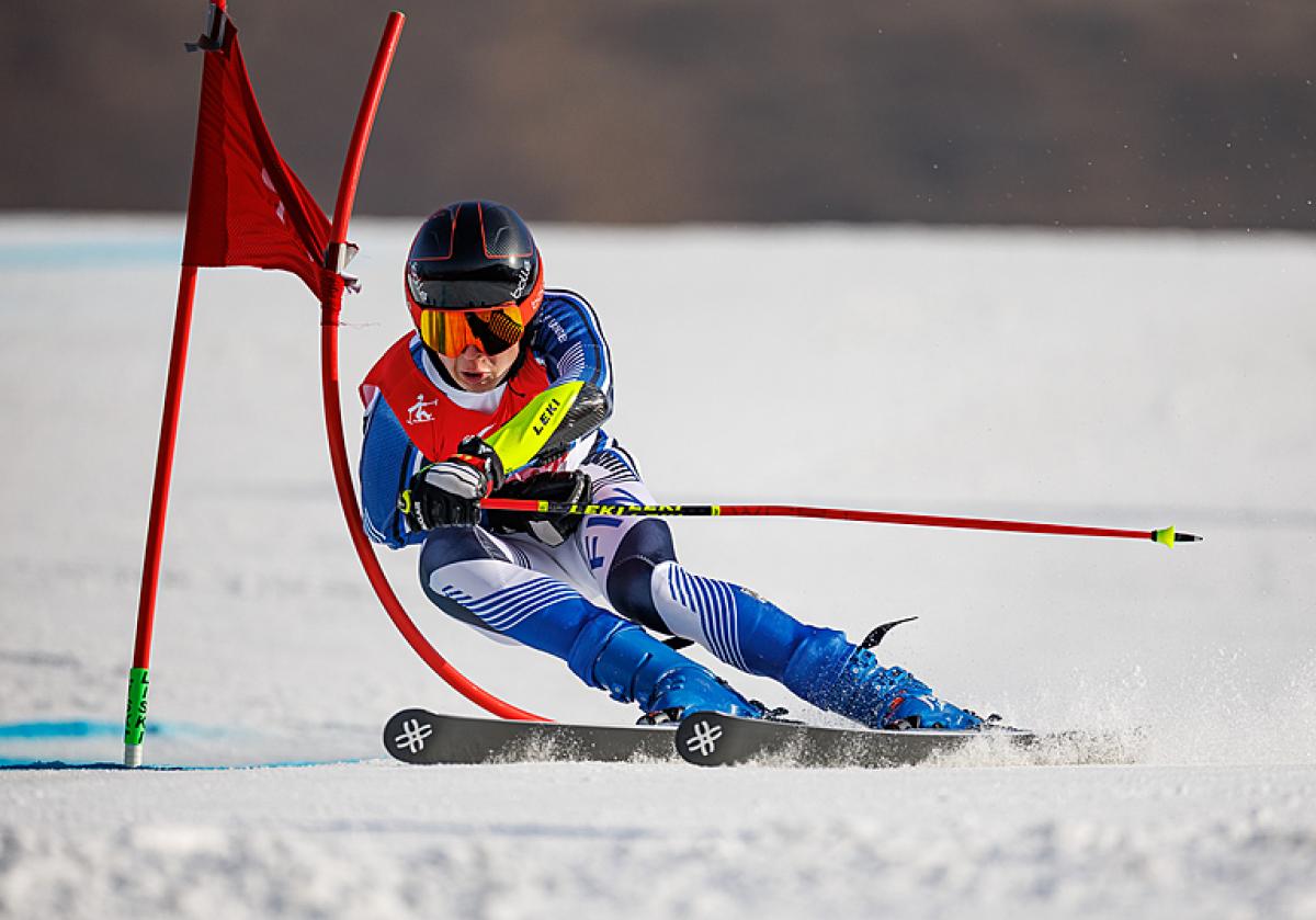 Finland's Santeri Kiiveri skis past a gate at Beijing 2022