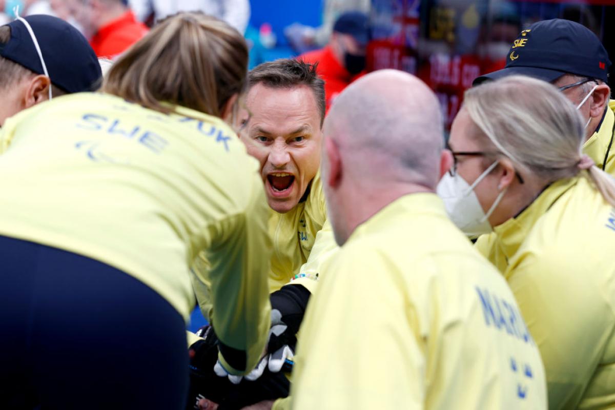 Ronny Persson #3 of Team Sweden gathers with his teammates for a cheer before competing in the Mixed Wheelchair Curling Round Robin Match between Great Britain and Sweden during Day Four of the Beijing 2022 Winter Paralympics at National Aquatics Centre