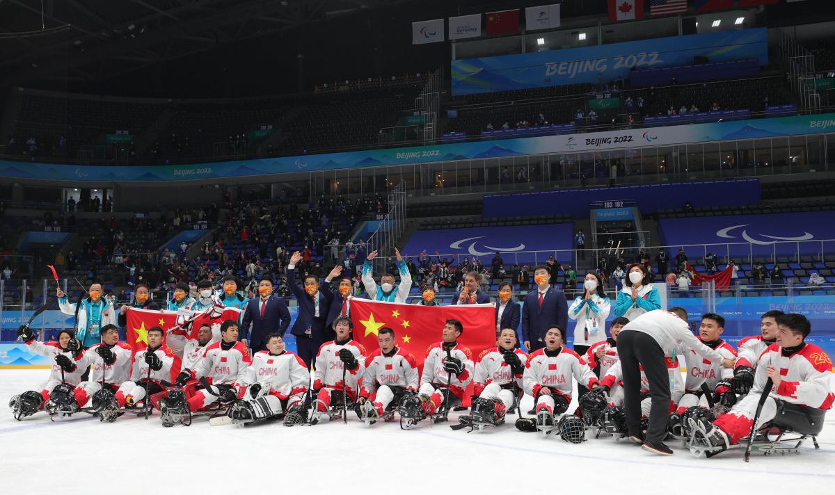 Group photo of Para ice hockey players and staff celebrating the win.