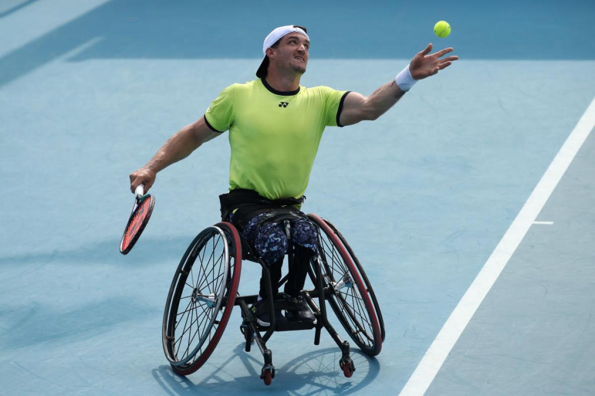 Argentina's Gustavo Fernandez serves in a doubles match at the 2022 Australian Open.