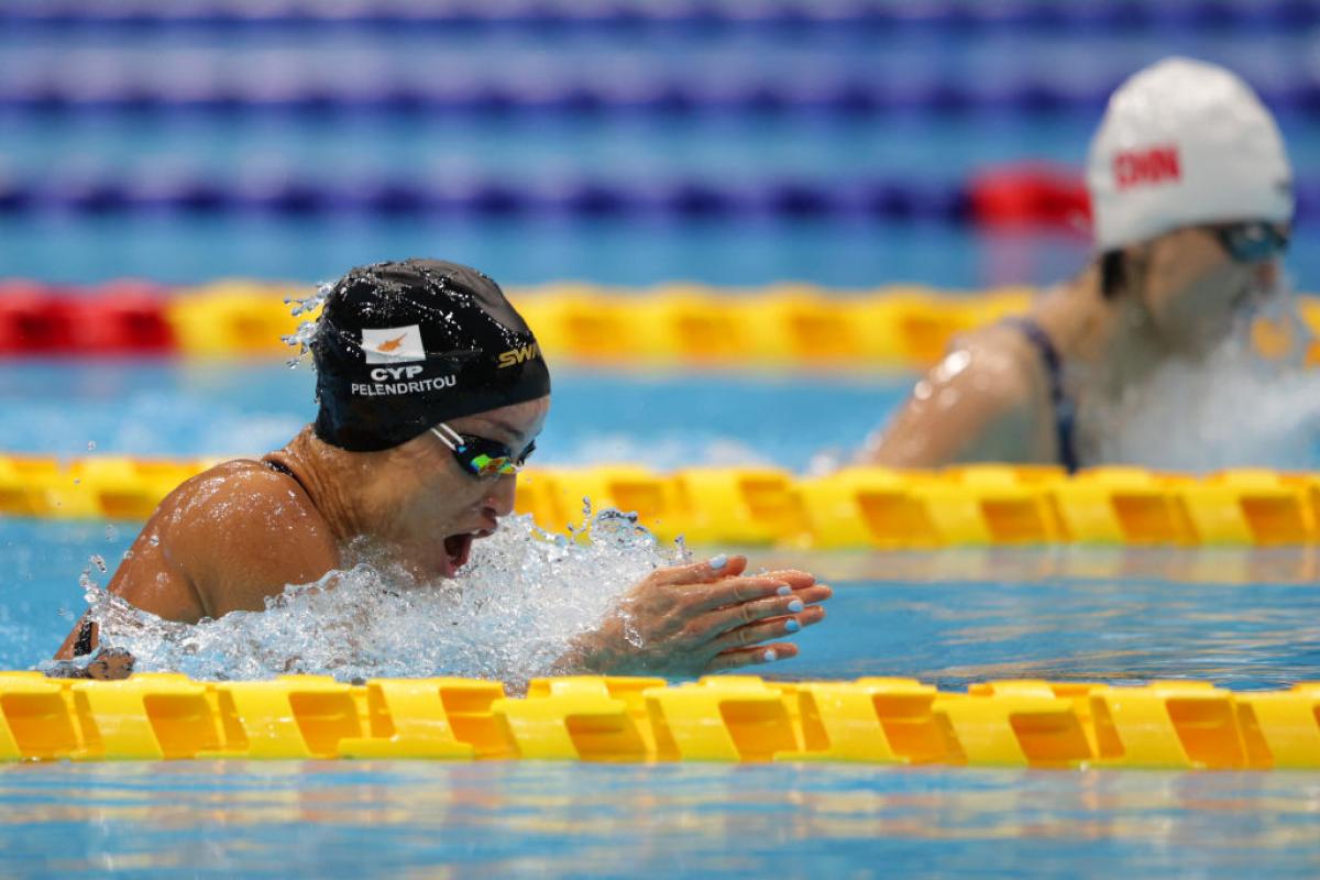 Two women swimming breaststroke in a pool