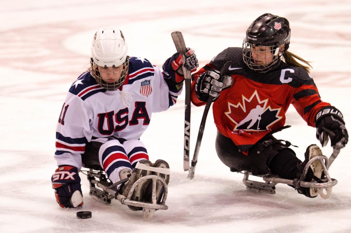 Image of two female Para ice Hockey players on the ice