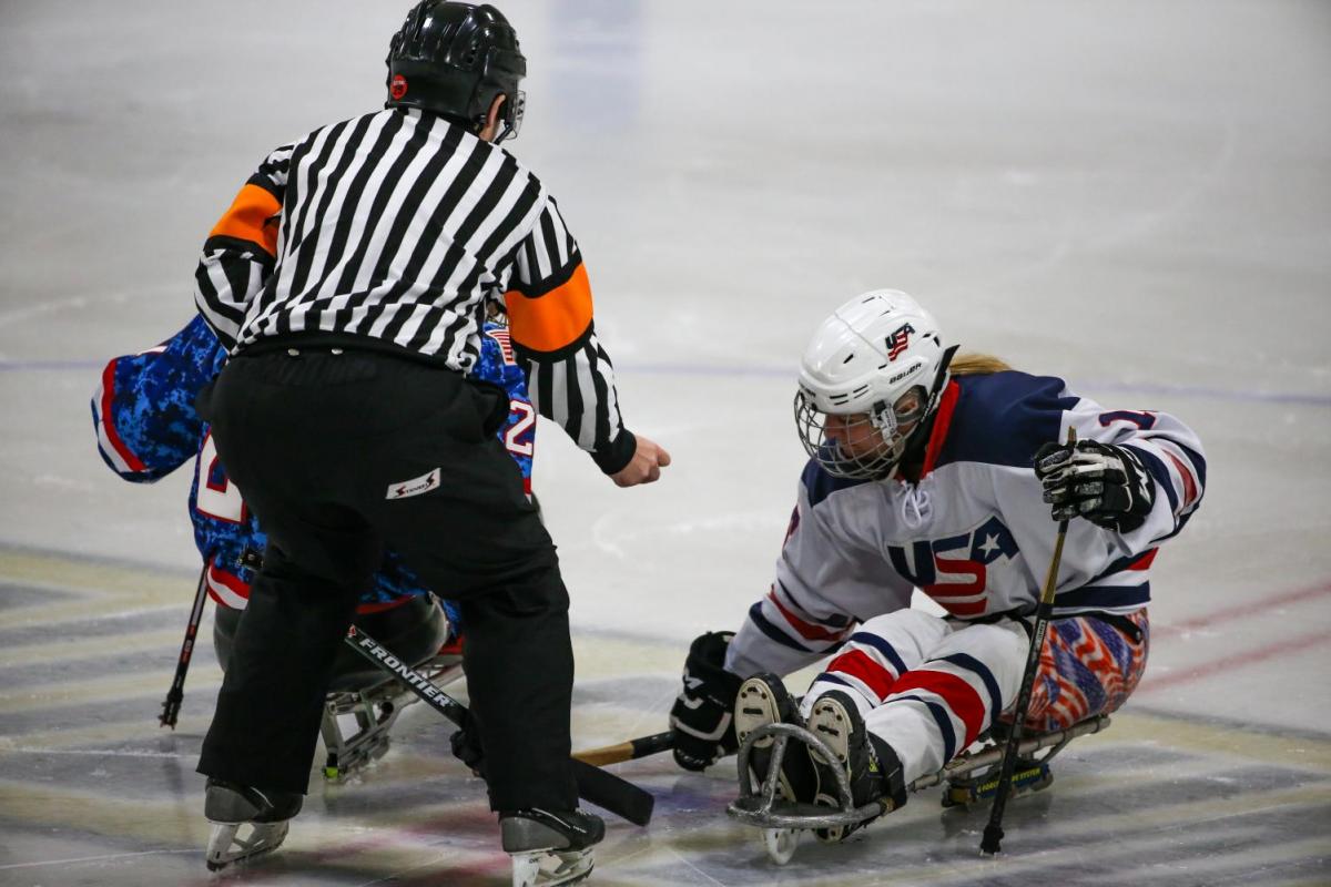 Image of a female para hockey player from USA on the ice for the beginning of the match