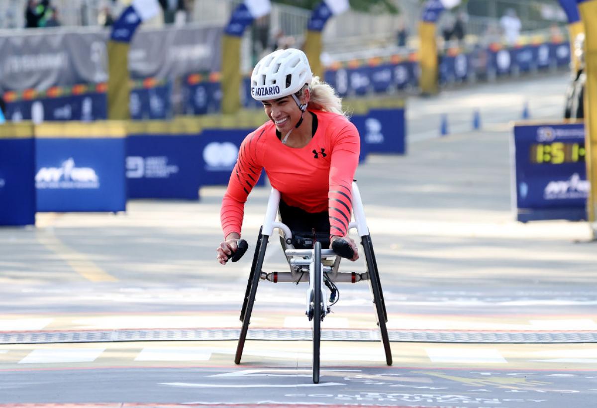A female wheelchair racer crossing the finish line at the New York City Marathon