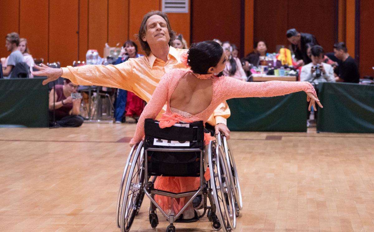 A pair of wheelchair dancers in a competition