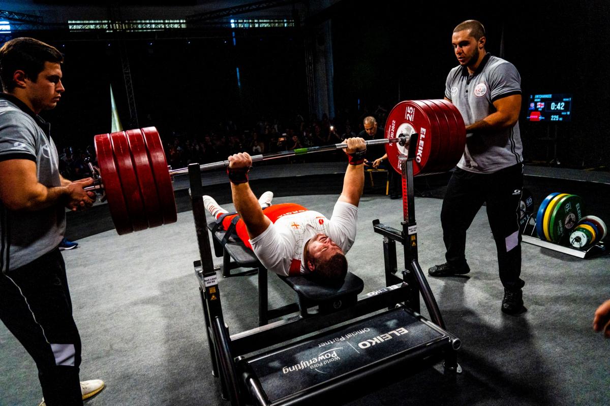 A heavyweight powerlifter prepares to make a lift with the audience watching on.