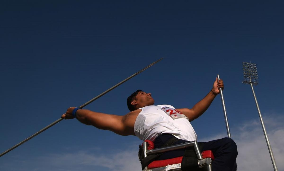 A male athlete in a chair competing in javelin throw