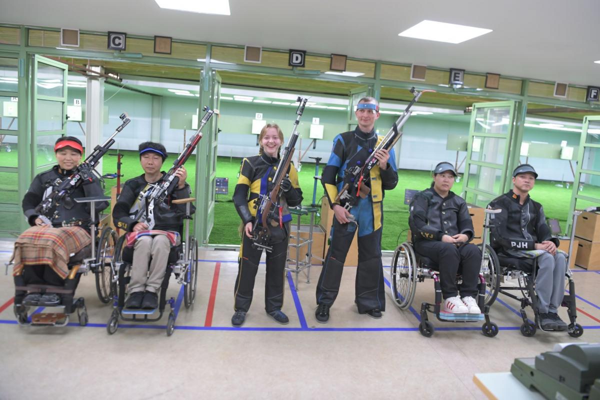 Medallists strike a pose after the end of the R10 - 10m air rifle standing mixed team SH1 finals at the Al Ain Equestrian, Shooting and Golf Club.