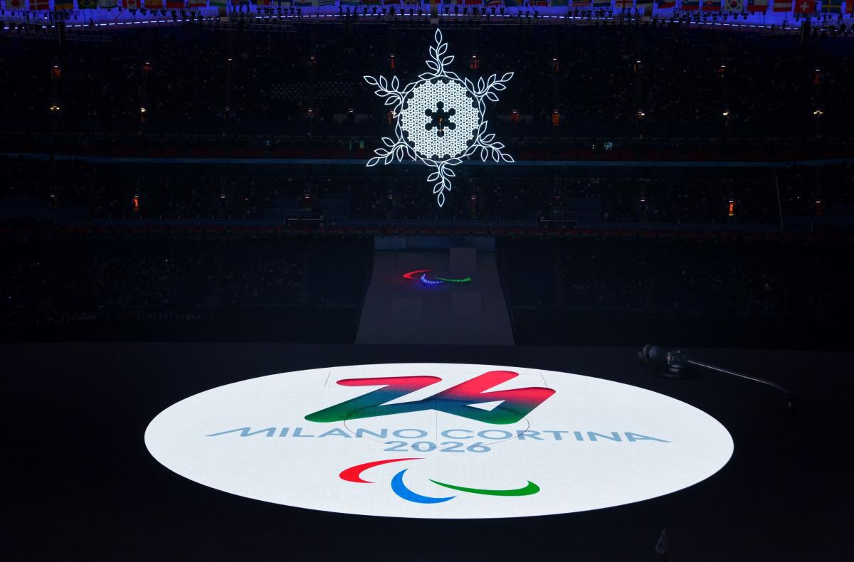 The logo of the Milano Cortina 2016 Paralympic Winter Games is projected as a bright white circle onto the stage during the handover at the Beijing 2022 Paralympic Winter Games Closing Ceremony.