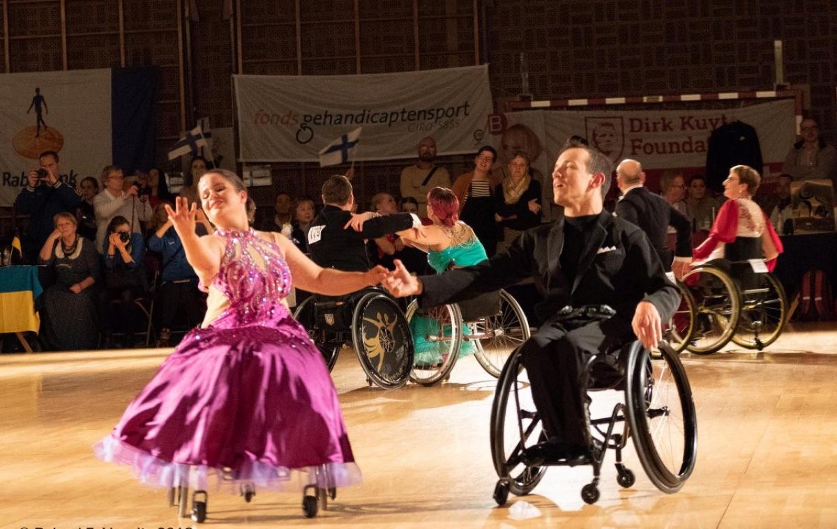 A female and a male wheelchair dancers in a Para dance sport competition