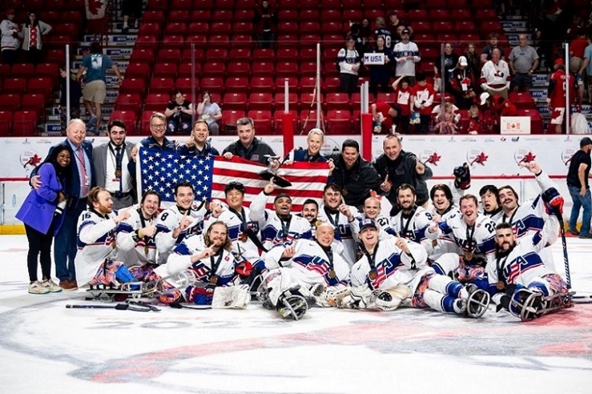 The USA Para ice hockey national team celebrating on ice at the Moose Jaw 2023 World Championships