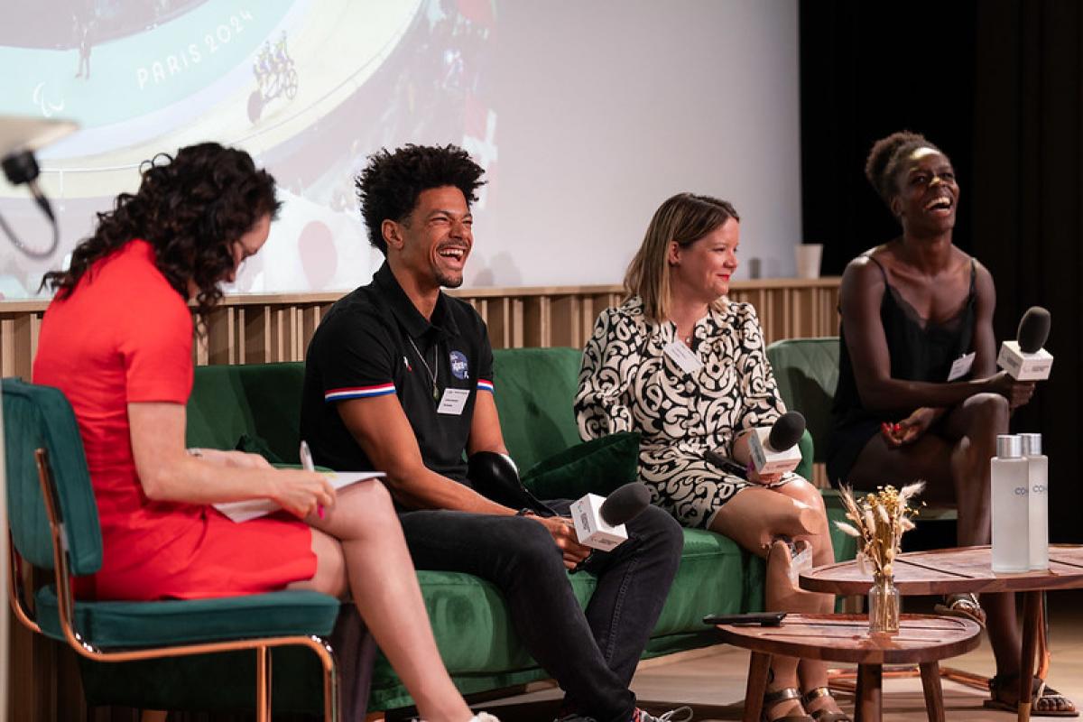 Four female and male Paralympians speak on stage.